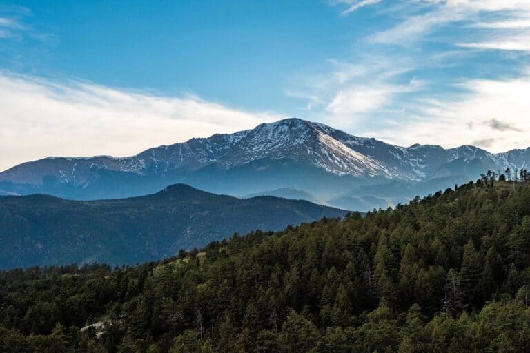 Image of Pikes Peak with wispy clouds and trees in foreground KHM Attorneys at Law Colorado Springs, Castle Rock