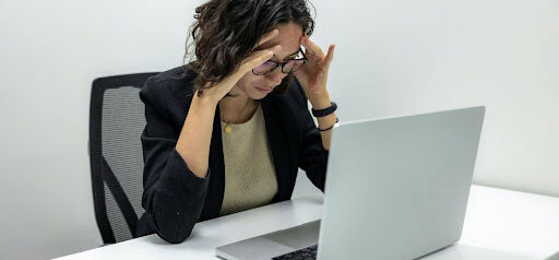 woman is unhappy looking at laptop computer KHM Attorneys at Law Colorado Springs, Castle Rock
