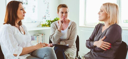 two women discuss the troubles with their relationship with a mediator listening KHM Attorneys at Law Colorado Springs, Castle Rock