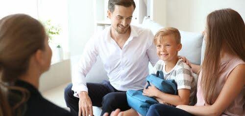 young boy sits between man and woman while speaking to a therapist about co-parenting KHM Attorneys at Law Colorado Springs, Castle Rock