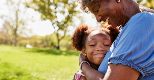 young girl hugs grandma at a park KHM Attorneys at Law Colorado Springs, Castle Rock